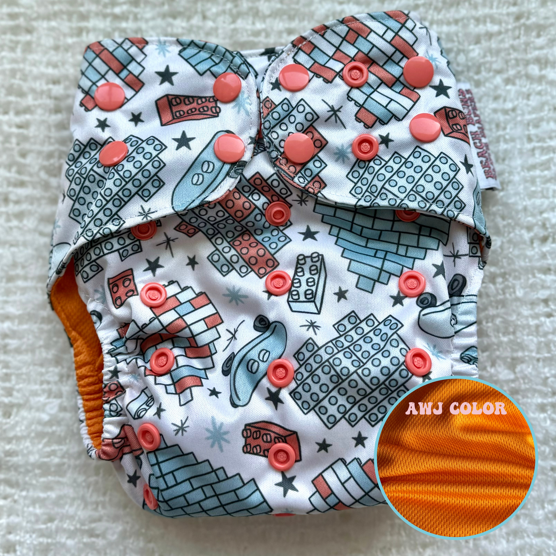 An assortment of colorful cloth diapers neatly stacked, showcasing a sustainable and eco-friendly diapering option for babies. The diapers display various vibrant patterns and soft fabrics, providing a reusable and comfortable solution for families.